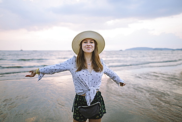 Young woman in sun hat on beach in Krabi, Thailand