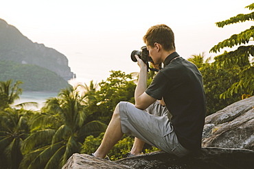 Man photographing palm trees on Phi Phi Islands, Thailand