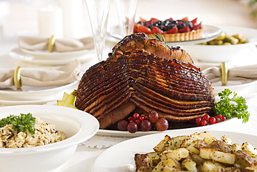 Spiral ham and side dishes on set table