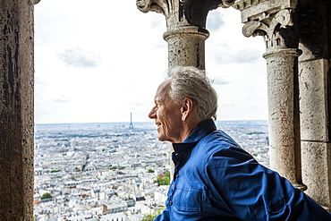 Smiling man by cityscape from Sacre Coeur in Paris, France