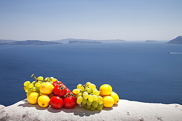 Fruit on white wall by sea, Santorini, Cyclades Islands, Greece