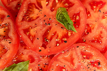 Sliced tomatoes with basil and pepper