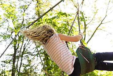 Girl wearing striped t-shirt on swing