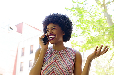 Smiling young woman on phone call