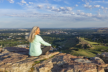 Mature woman sitting on rocks in Boise, Idaho, USA