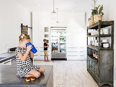 Girl drinking on kitchen counter