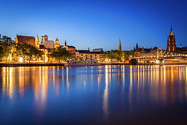 Buildings by river at sunset in Frankfurt, Germany