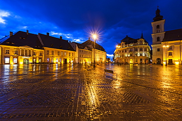 Wet Grand Square at sunset in Sibiu, Romania