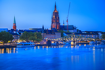 Cathedral by river at sunset in Frankfurt, Germany