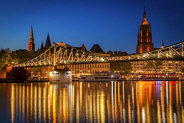 Bridge over river at sunset in Frankfurt, Germany