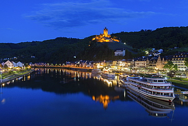 Town and Cochem Imperial Castle by river at sunset in Cochem, Germany