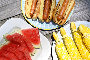 Watermelon, hot dogs and corn cobs