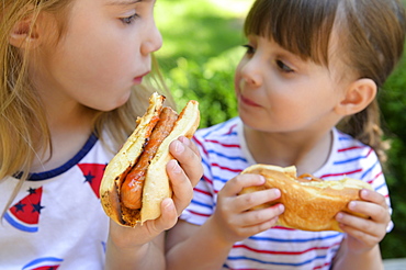 Girls eating hot dogs