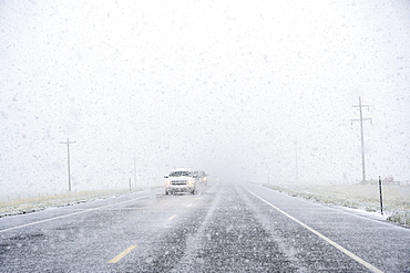 View through windscreen of car on highway during snow