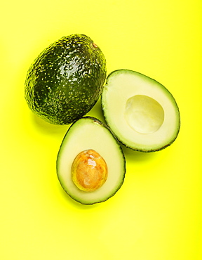 Avocados on green surface