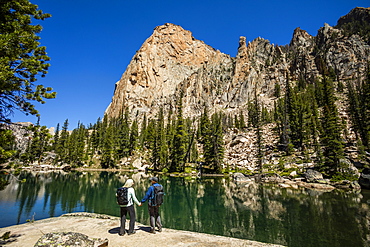 Couple holding hands by river in Sawtooth Mountains in Stanley, Idaho, USA