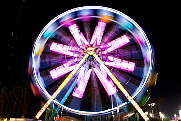 Blurred image of Ferris wheel at night at Santa's Enchanted Forest in Miami, Florida, United States of America