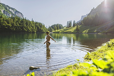 Woman swimming in Seealpsee lake in Appenzell Alps, Switzerland