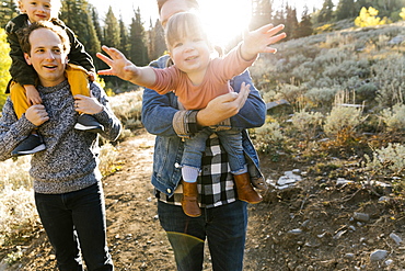 Two fathers and daughters while hiking