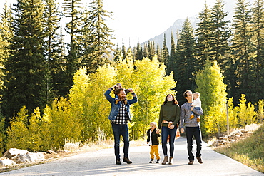 Family and friends on road through forest