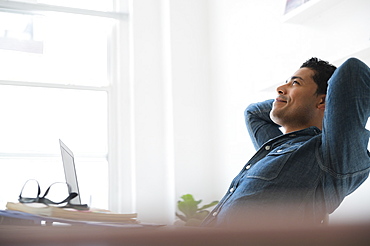 Businessman relaxing at office desk