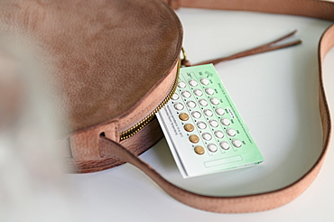 Birth control next to purse