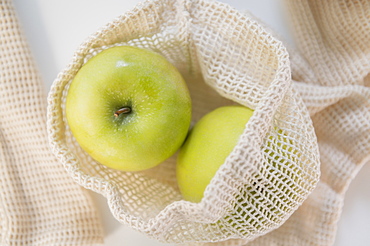 Green apples in reusable bag