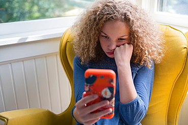 Bored girl using smartphone