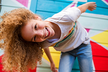 Girl in front of colorful wall