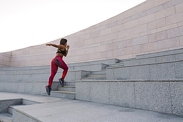 Woman running up steps, Lisboa, Lisbon, Portugal