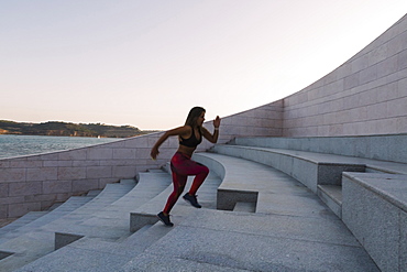 Woman running up steps, Lisboa, Lisbon, Portugal