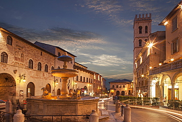 Fountain in Piazza del Comune at sunset in Assisi, Italy