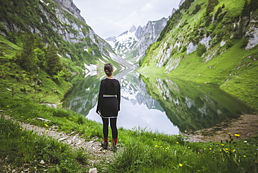 Woman by mountains and lake in Appenzell, Switzerland