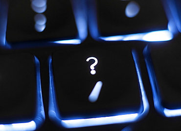 Illuminated question mark key on keyboard