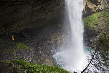 Woman in jacket by waterfall