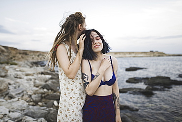 Young women standing together on beach