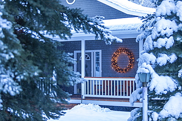 Illuminated Christmas wreath on house during winter