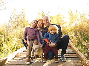 Smiling family on forest boardwalk