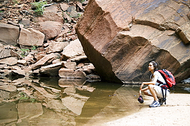 Female backpacker relaxing at a mountain lake