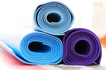 Pile of yoga mats on floor