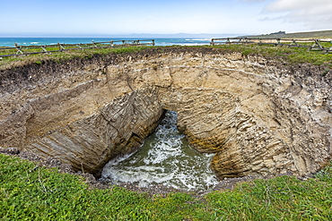 USA, California, San Luis Obispo, Sinkhole at edge of coastal bluff