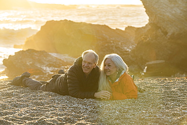 Senior couple enjoying sunset on beach