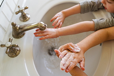 Close-up of children (4-5, 6-7) washing hands