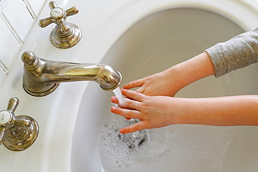 Close-up of boy (4-5) washing hands