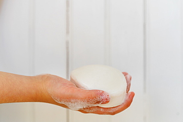 Close-up of girls (6-7) hand holding soap