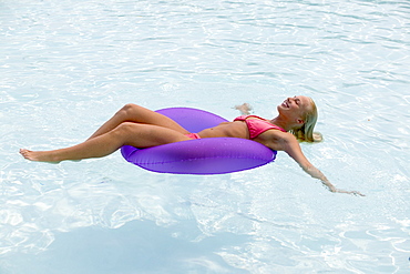 Woman floating in a swimming pool