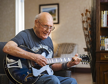 Senior man playing guitar