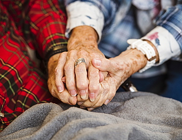 Senior couple holding hands