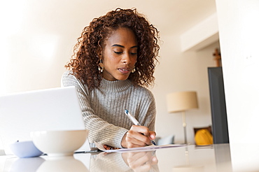 Woman doing paperwork at home