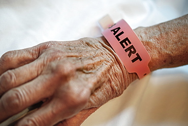 Alert tag around senior person's wrist